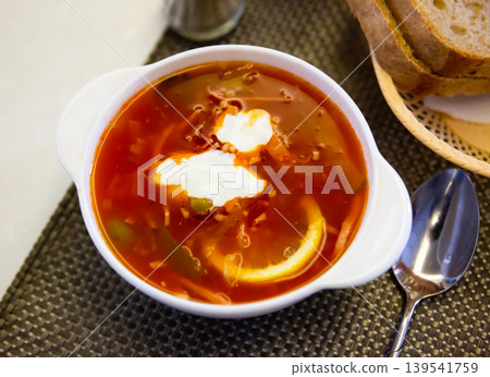 Russian meat soup solyanka with assorted meat and sausages and vegetables Russian meat soup solyanka with assorted meat and sausages and vegetables 139541759