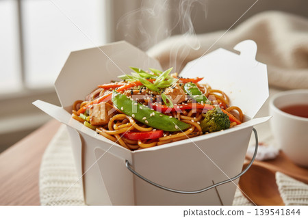 Steaming stir-fried noodles with tofu and vegetables in a takeout box 139541844