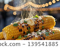 Steaming grilled corn on the cob with toppings 139541885