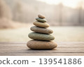 Stone balance on a wooden surface with blurred background 139541886