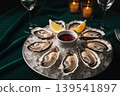 Fresh oysters served on ice with lemon and sauce in a luxurious setting 139541897