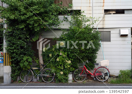 An old wooden apartment building and a bicycle An old wooden apartment building and a bicycle 139542597