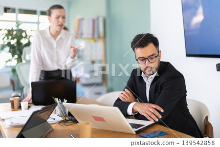 Female manager is dissatisfied with work of an employee - yells and reproaches her Female manager is dissatisfied with work of an employee - yells and reproaches her 139542858
