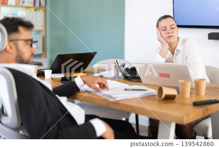 Tired man and girl sleeps next to computer at work 139542860