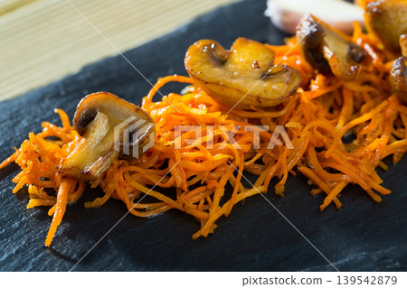 Slate of freshly fried mushrooms with carrot Slate of freshly fried mushrooms with carrot 139542879