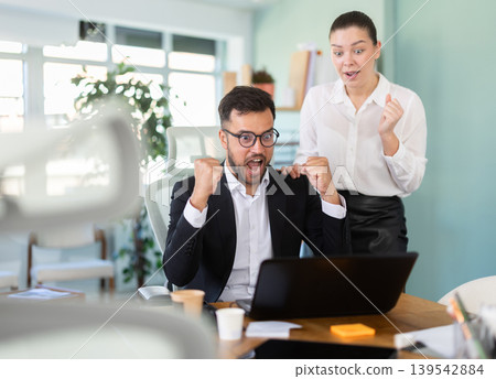 Man and girl office employees is genuinely happy and elated Man and girl office employees is genuinely happy and elated 139542884