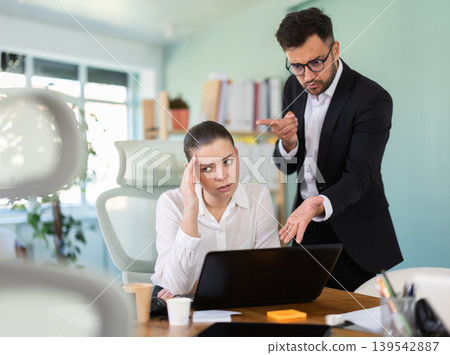 Manager is dissatisfied with the work of an employee - yells and reproaches her Manager is dissatisfied with the work of an employee - yells and reproaches her 139542887