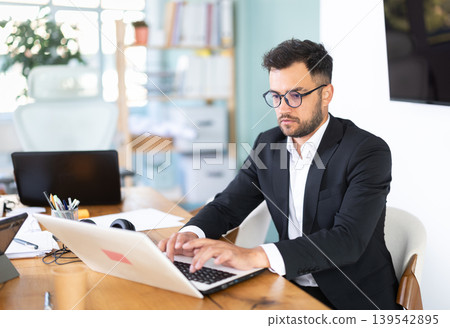 Man working in office, manager using laptop in work Man working in office, manager using laptop in work 139542895