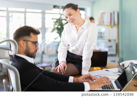 Girl harasses her male boss at work Girl harasses her male boss at work 139542896