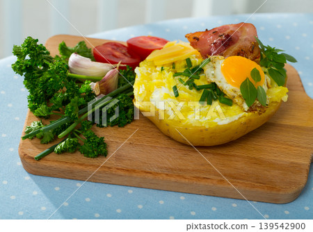 Baked potato stuffed with herbs, egg, bacon Baked potato stuffed with herbs, egg, bacon 139542900