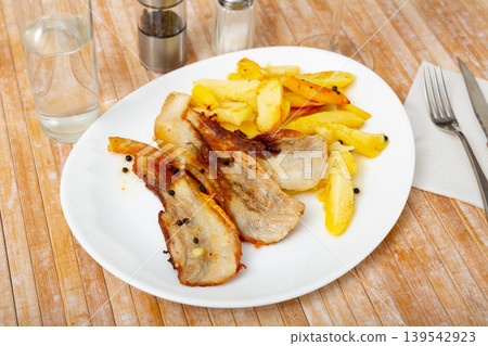 Fried pork with potatoes 139542923