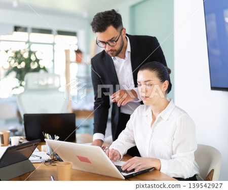 Male manager helping to woman during working at laptop Male manager helping to woman during working at laptop 139542927