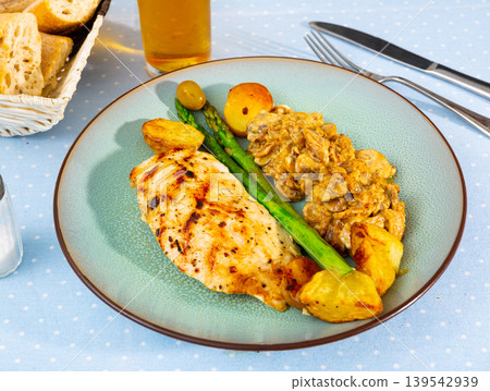 Tasty baked chicken breast with mushrooms in sauce and potatoes 139542939