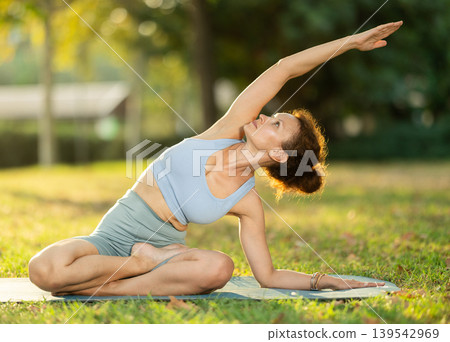 Adult woman doing yoga in lotus position Adult woman doing yoga in lotus position 139542969