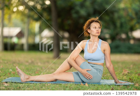 Adult woman doing stretching in park Adult woman doing stretching in park 139542978