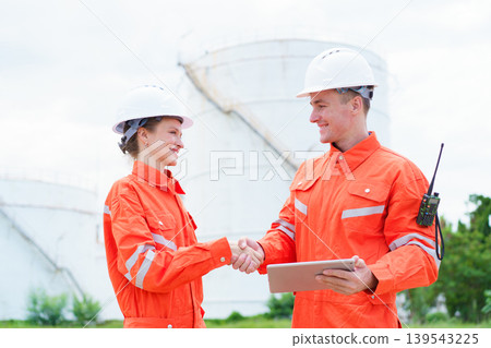 Male and female engineers agreement handshake in industry Male and female engineers agreement handshake in industry 139543225