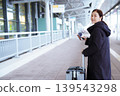 Asian woman with suitcase using smartphone at airport 139543298