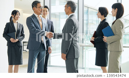 Group of business people shaking hands in the office Group of business people shaking hands in the office 139543474