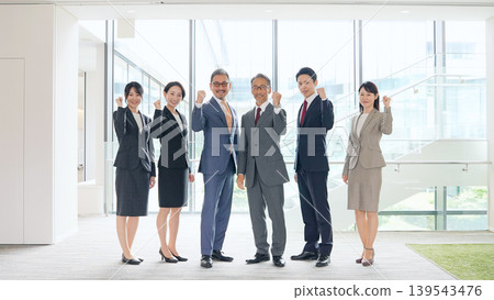 一群商務人士在辦公室揮舞著拳頭 一群商務人士在辦公室揮舞著拳頭 139543476