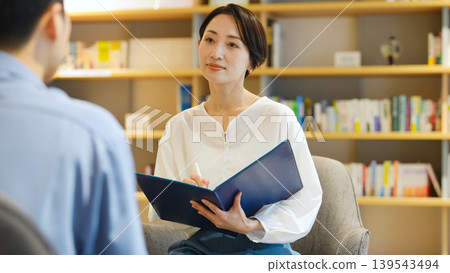 A man and a woman having an interview A man and a woman having an interview 139543494