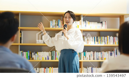 A woman giving a speech and the audience A woman giving a speech and the audience 139543497