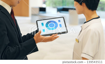 Female medical staff receiving an explanation from a sales representative Female medical staff receiving an explanation from a sales representative 139543511