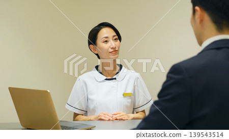 Female medical staff serving customers Female medical staff serving customers 139543514