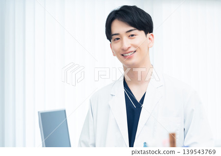 A young man working at a hospital A young man working at a hospital 139543769