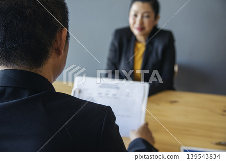 Job HR applicants having an interview with Human resource manager jobs interviewing with confident candidate at business firm office give cv resume. Job Interview with headhunter agent and applicant Job HR applicants having an interview with Human resource manager jobs interviewing with confident candidate at business firm office give cv resume. Job Interview with headhunter agent and applicant 139543834
