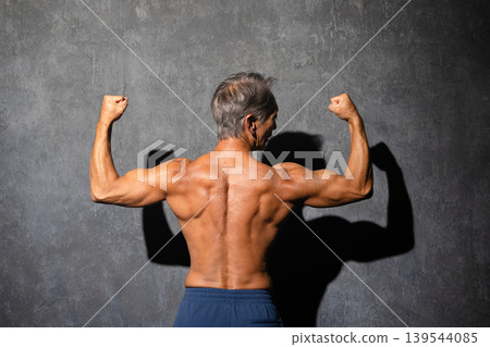 Senior man posing shirtless in bodybuilding poses Sports image Senior man posing shirtless in bodybuilding poses Sports image 139544085