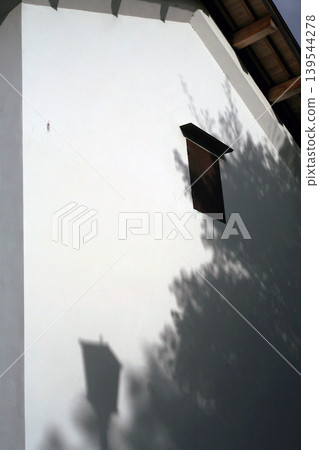 The shadows of trees cast on the earthen storehouse The shadows of trees cast on the earthen storehouse 139544278