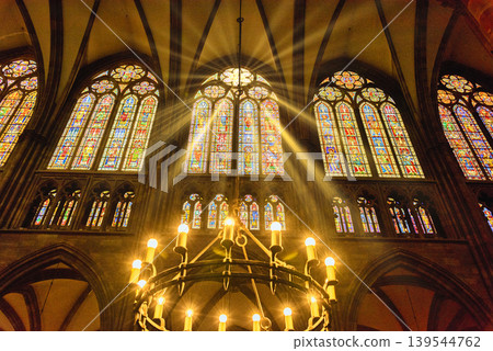 Sunlight shining through the rose window of Notre Dame de Strasbourg Cathedral (composite image) Sunlight shining through the rose window of Notre Dame de Strasbourg Cathedral (composite image) 139544762