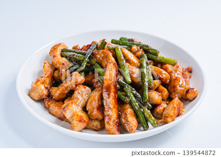 Stir-fried pork loin and garlic sprouts: A hearty meat and vegetable stir-fry (white background) Stir-fried pork loin and garlic sprouts: A hearty meat and vegetable stir-fry (white background) 139544872