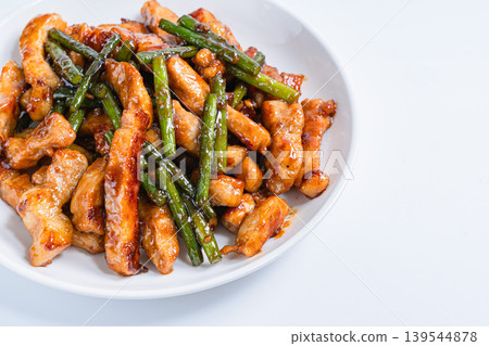 Stir-fried pork loin and garlic sprouts: A hearty meat and vegetable stir-fry (white background) Stir-fried pork loin and garlic sprouts: A hearty meat and vegetable stir-fry (white background) 139544878
