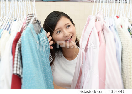 A woman choosing clothing 139544931