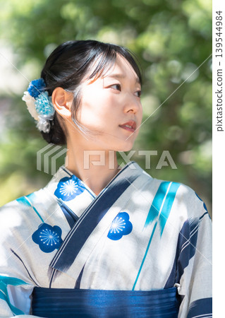 Japanese woman in yukata strolling through a garden: A Japanese-style portrait, a summer memory. Japanese woman in yukata strolling through a garden: A Japanese-style portrait, a summer memory. 139544984