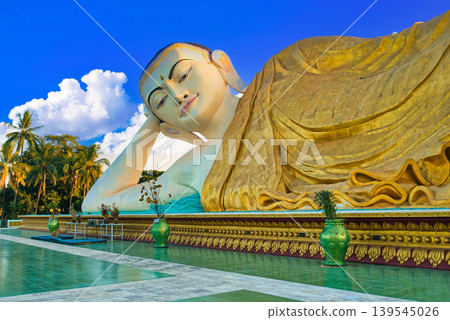 The breathtaking view of the Myatthalyaung Reclining Buddha in Bago, combined with clouds. The breathtaking view of the Myatthalyaung Reclining Buddha in Bago, combined with clouds. 139545026