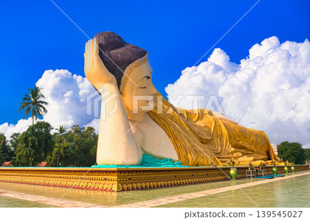 The breathtaking view of the Myatthalyaung Reclining Buddha in Bago, combined with clouds. The breathtaking view of the Myatthalyaung Reclining Buddha in Bago, combined with clouds. 139545027