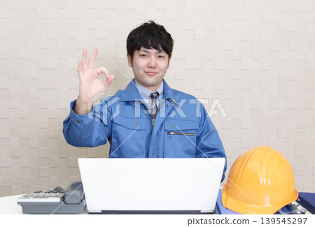 A worker makes an OK sign gesture. A worker makes an OK sign gesture. 139545297