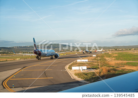 Airplanes on the runway at Palma de Mallorca Airport ready for takeoff on a sunny day Airplanes on the runway at Palma de Mallorca Airport ready for takeoff on a sunny day 139545485