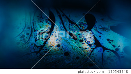 Holographic texture. Paint blend. Defocused blue purple orange color chemical round oil water liquid leak on abstract art dark black background. Holographic texture. Paint blend. Defocused blue purple orange color chemical round oil water liquid leak on abstract art dark black background. 139545548