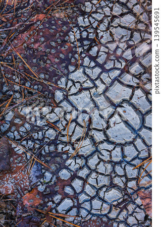 Cracked Earth. An arid landscape with cracked, dry earth patterns in a warm orange hue Cracked Earth. An arid landscape with cracked, dry earth patterns in a warm orange hue 139545691