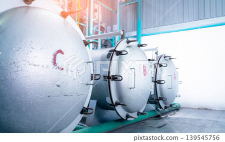 High pressure processing machine with stainless steel tank in modern food manufacturing factory, industrial equipment used for hydrostatic pasteurization eliminating pathogens. Safe food preservation. High pressure processing machine with stainless steel tank in modern food manufacturing factory, industrial equipment used for hydrostatic pasteurization eliminating pathogens. Safe food preservation. 139545756