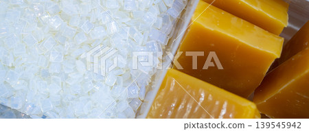 Hot melt adhesive pellets and glue blocks used in food labeling and packaging, thermoplastic polymer material for industrial bonding application. Non toxic safety, chemical industry process. 139545942