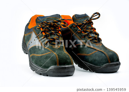Pair of black safety leather shoes on white background, protective work footwear for men in factory or industrial environment. Oil and acid resistance. Workplace safety and accident prevention. 139545959