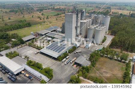 Aerial view of animal feed factory. Agricultural silos, grain storage silos, and solar panel on roofs of industrial plants. Industrial landscape. Agriculture industry. Factory with sustainable energy. Aerial view of animal feed factory. Agricultural silos, grain storage silos, and solar panel on roofs of industrial plants. Industrial landscape. Agriculture industry. Factory with sustainable energy. 139545962