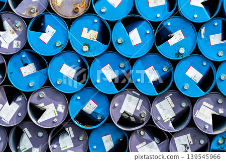 Old chemical barrels. Blue and purple oil drum. Steel oil tank. Toxic waste warehouse. Hazard chemical barrel with warning label. Industrial waste in metal drum. Hazard waste storage in factory. Old chemical barrels. Blue and purple oil drum. Steel oil tank. Toxic waste warehouse. Hazard chemical barrel with warning label. Industrial waste in metal drum. Hazard waste storage in factory. 139545966