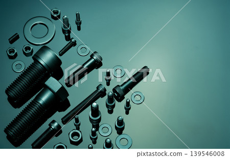 Metal Bolts, nuts, and washers. Fasteners equipment. Hardware tools. Stud bolt, flat washers, hex nuts, and hex head bolts in workshop. Threaded fastener use in automotive engineering. Hexagonal bolt. Metal Bolts, nuts, and washers. Fasteners equipment. Hardware tools. Stud bolt, flat washers, hex nuts, and hex head bolts in workshop. Threaded fastener use in automotive engineering. Hexagonal bolt. 139546008