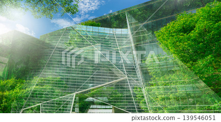 Sustainble green building. Eco-friendly building. Sustainable glass office building with tree for reducing carbon dioxide. Office with green environment. Corporate building reduce CO2. Safety glass. 139546051