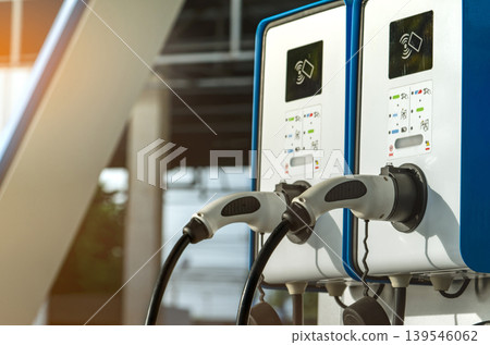 Electric car charging station for charge EV battery. Plug for vehicle with electric and hybrid engine. EV charger. Clean energy. Charging point for EV car. Green power. Future transport technology. Electric car charging station for charge EV battery. Plug for vehicle with electric and hybrid engine. EV charger. Clean energy. Charging point for EV car. Green power. Future transport technology. 139546062